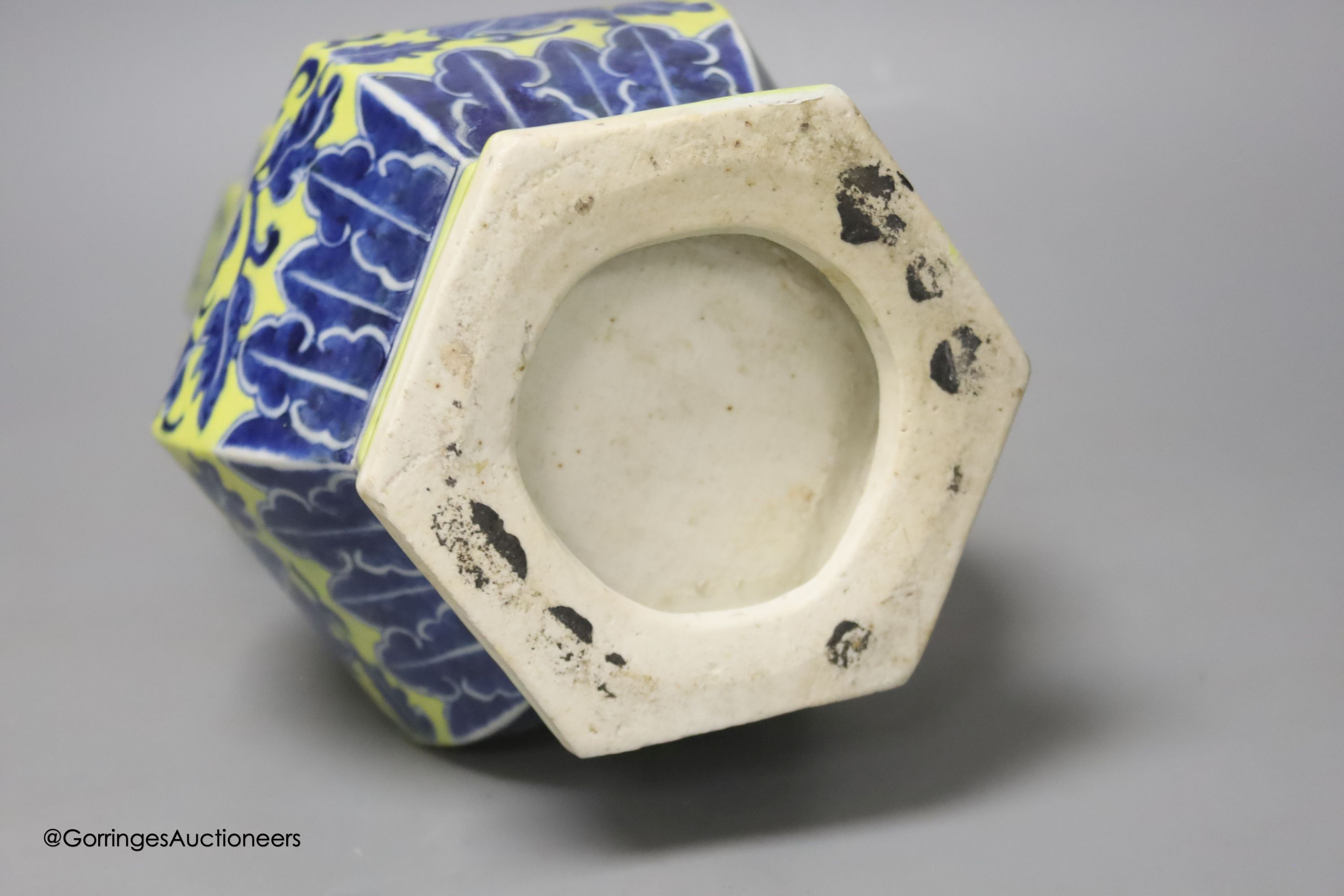 A Chinese underglaze blue yellow ground hexagonal vase, early 20th century, some restoration 35cm